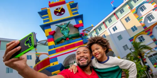 Father and son taking a selfie in front of the Legoland Hotel